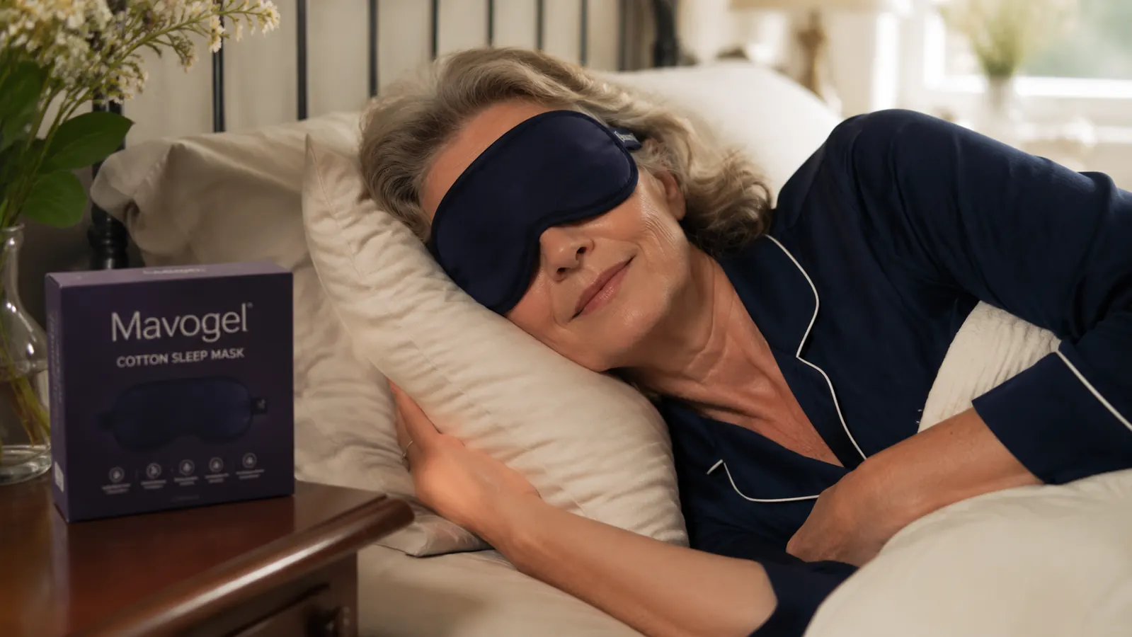 Woman wearing the Mavogel cotton sleep mask while lying on her side in bed